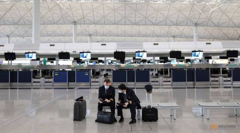 This image has an empty alt attribute; its file name is file-photo-pilots-wearing-face-masks-to-avoid-the-spread-of-the-coronaviru-at-the-hong-kong-international-airport-in-hong-kong-1.jpg