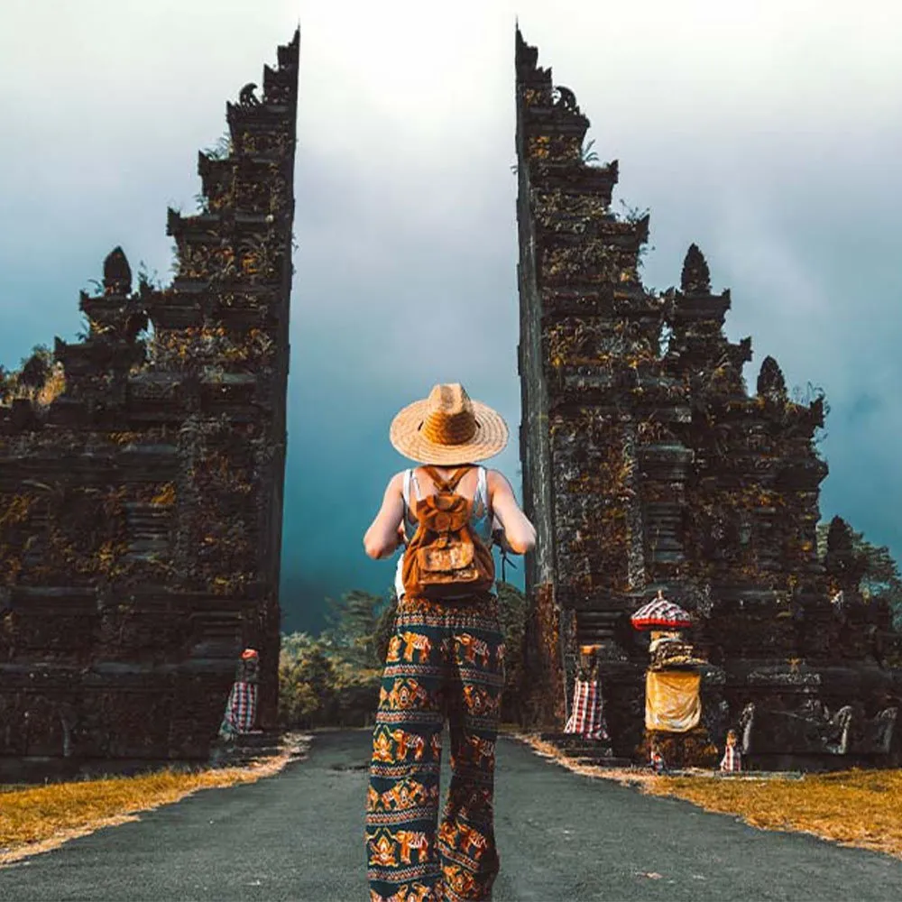 This image has an empty alt attribute; its file name is indonesia-bali-tourists-news-temple-entrance_featured.webp